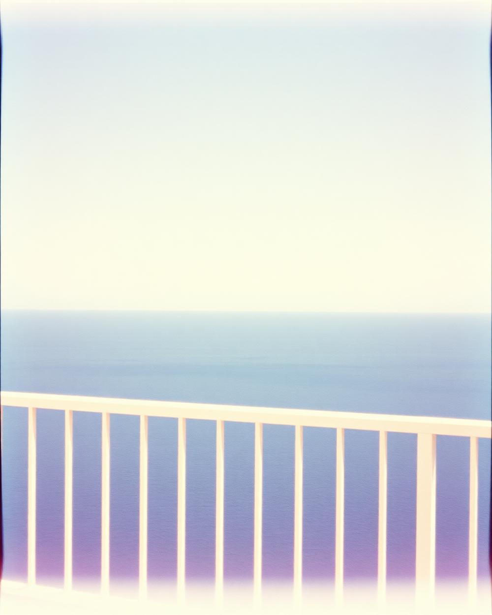 Pale sea seen from a balcony railing