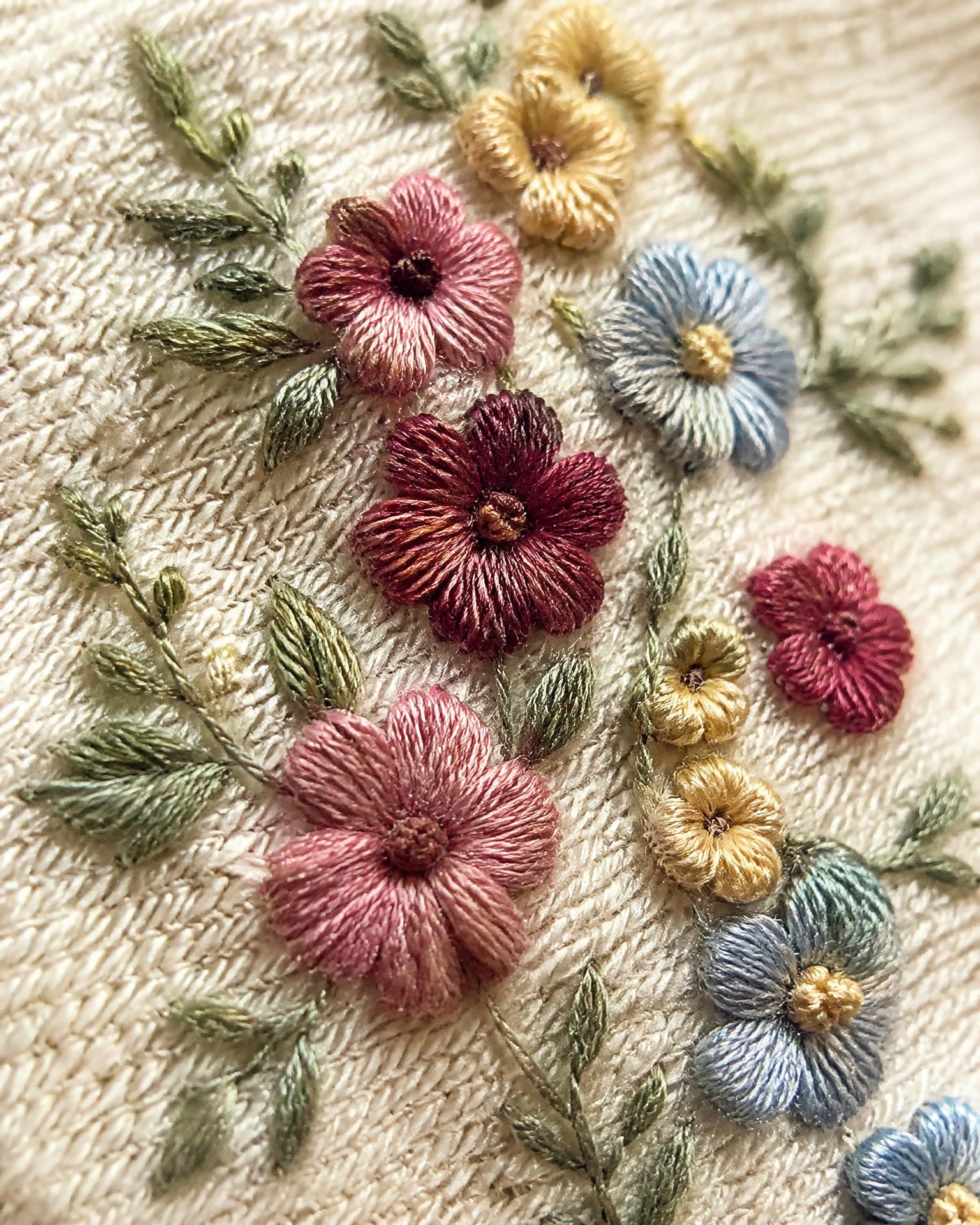 Macro Close-Up of the botanical embroidery thread on Petal Cove Low-Rise Shorts