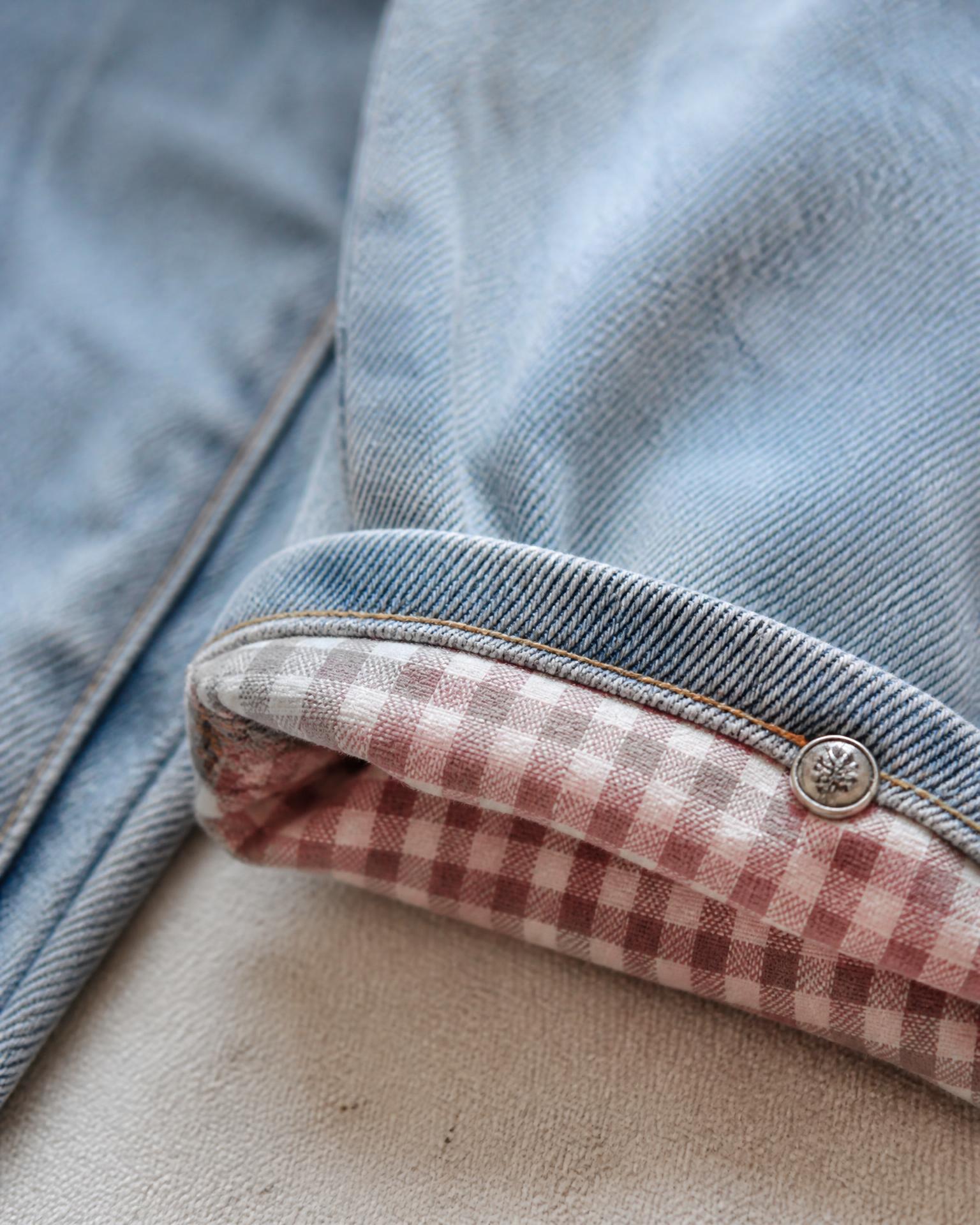 Close-Up of the hidden dusty rose gingham cuff lining on Shellwash Baggy Jeans